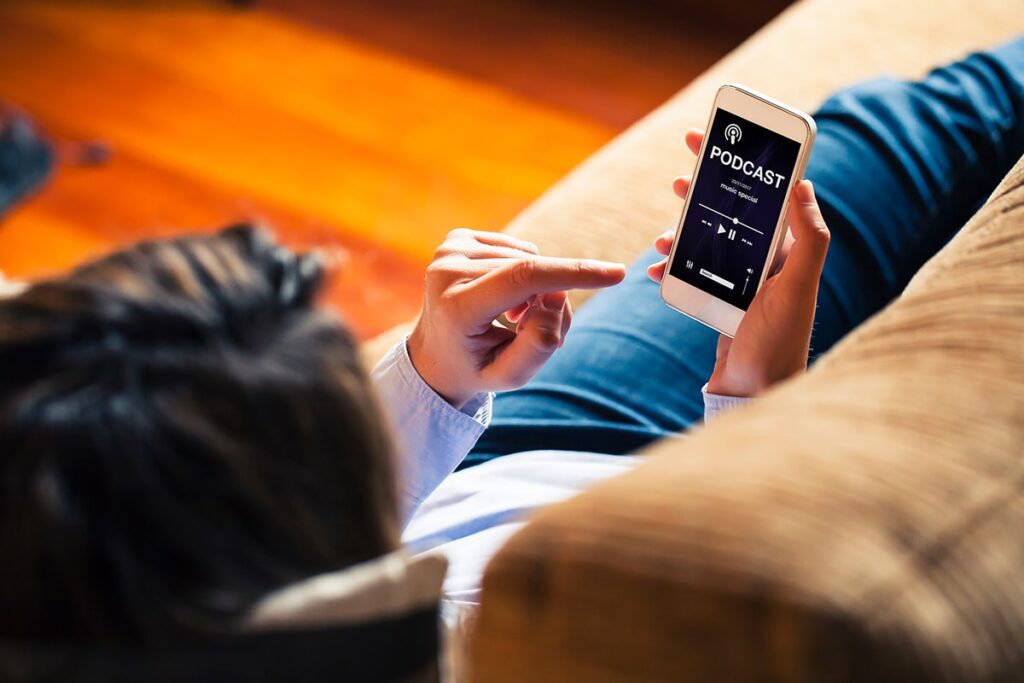 Make Money with Podcasting — Woman Listening Podcast on a Mobile Phone Make Money with Podcasting — Woman Listening Podcast on a Mobile Phone
